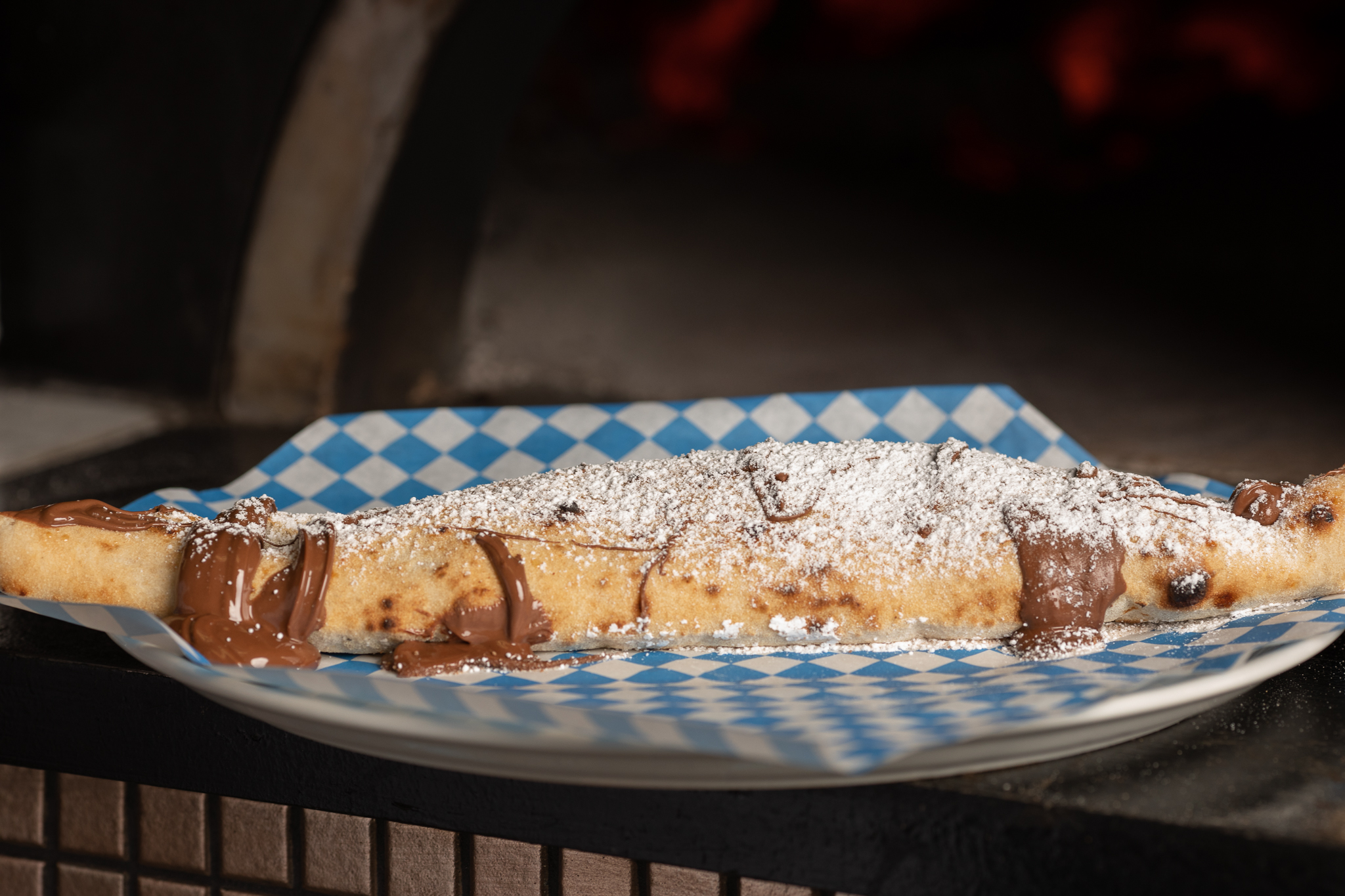 Nutella & ricotta stuffed calzone baked & then finished off with Nutella & powdered sugar
